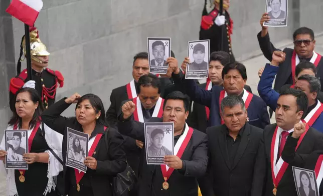Opposition lawmakers hold photos of people killed during protests following the ouster of former President Pedro Castillo outside Congress during the swearing-in ceremony of Peru's new President Keiko Fujimori in Lima, Peru, Tuesday, July 28, 2026. (AP Photo/Miguel Paredes)