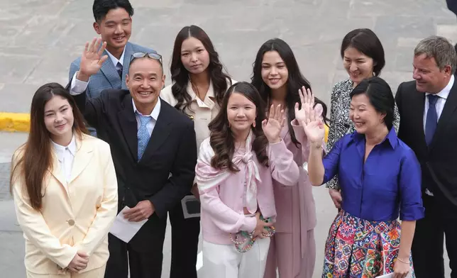 Keiko Fujimori's family waves as they arrive at Congress for her inauguration in Lima, Peru, Tuesday, July 28, 2026.(AP Photo/Miguel Paredes)