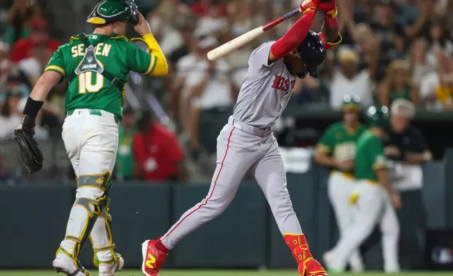 Boston Red Sox's Ceddanne Rafaela, right, reacts after striking out to end the top of the eighth inning of a baseball game against the Athletics Tuesday, July 28, 2026, in West Sacramento, Calif. (AP Photo/Scott Marshall)