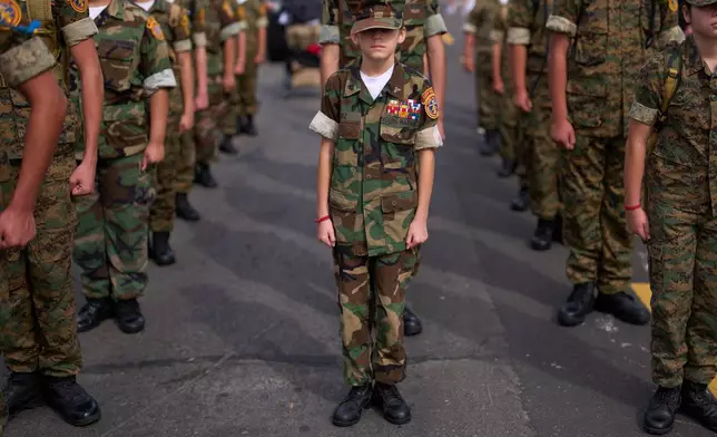 Members of the Young Marines stand at attention before an Independence Day parade Saturday, July 4, 2026, in Coronado, Calif. (AP Photo/Gregory Bull)