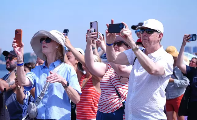 People watch as the French Air Force acrobatic squad Patrouille de France perform a flyover during the International Aerial Review, Saturday, July 4, 2026, in New York. (AP Photo/Sydney Schaefer)