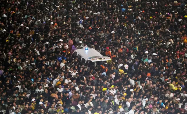 An ambulance is surrounded by pilgrims during the annual Hindu chariot procession of Lord Jagannath, in Puri, India, Thursday, July 16, 2026. (AP Photo/Ananya Das)
