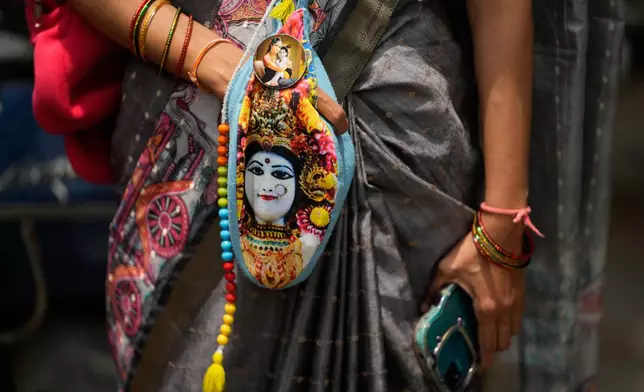 A Hindu devotee carrying prayer beads inside a bag while participating in the annual chariot procession of Hindu deity lord Jagannath in Hyderabad, India, Thursday, July 16, 2026. (AP Photo/Mahesh Kumar A.)