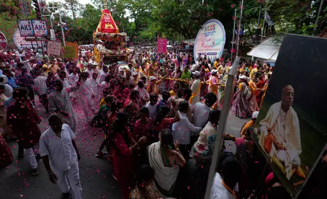 Devotees of the International Society for Krishna Consciousness (ISKCON) pull a rath (chariot) during the annual chariot procession of Hindu deity lord Jagannath in Hyderabad, India, Thursday, July 16, 2026. (AP Photo/Mahesh Kumar A.)