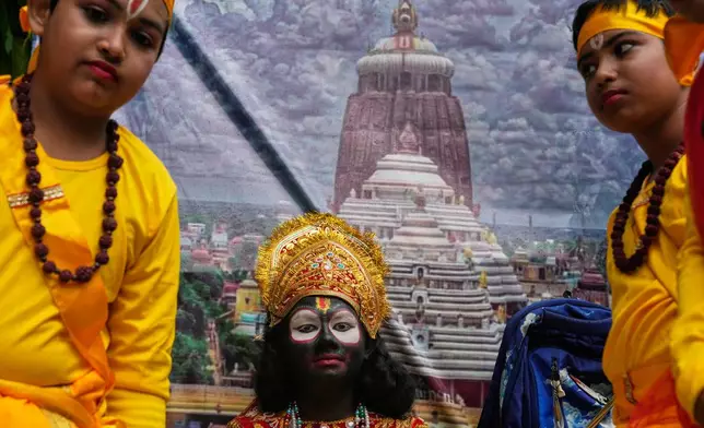 A child, centre, dressed as Hindu deity Jagannath travel on a chariot as they participate in a religious procession during the Rath Yatra, or chariot festival, carrying the Hindu deities of Jagannath, Balaram and Subhadra, in Kolkata, India, Thursday, July 16, 2026. (AP Photo/Bikas Das)