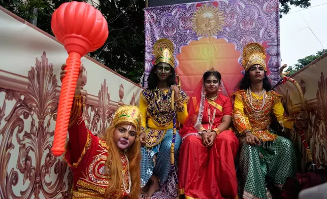 Children dressed as Hindu deities Rama and wife Sita, Lakshman and monkey god Hanuman travel on a chariot as they participate in a religious procession during the Rath Yatra, or chariot festival, carrying the Hindu deities of Jagannath, Balaram and Subhadra, in Kolkata, India, Thursday, July 16, 2026. (AP Photo/Bikas Das)