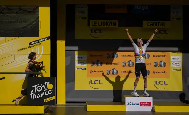 Slovenia's Tadej Pogacar celebrates on the podium after winning the tenth stage of the Tour de France cycling race with start in Aurillac and finish in Le Lioran, France, Tuesday, July 14, 2026. (AP Photo/Thibault Camus)