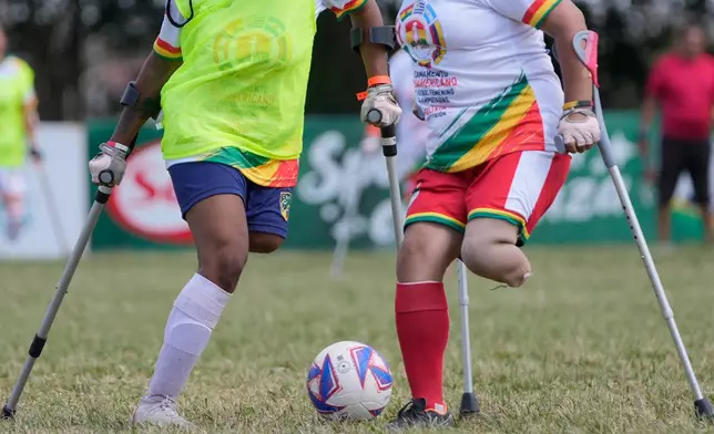 Players vie for the ball during a women's amputee soccer clinic Santa Cruz, Bolivia, Friday, July 17, 2026. (AP Photo/Juan Karita)