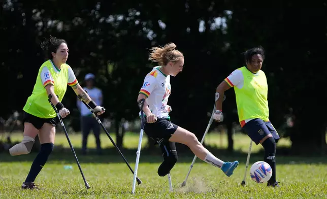 Players vie for the ball during a women's amputee soccer clinic in Santa Cruz, Bolivia, Friday, July 17, 2026. (AP Photo/Juan Karita)