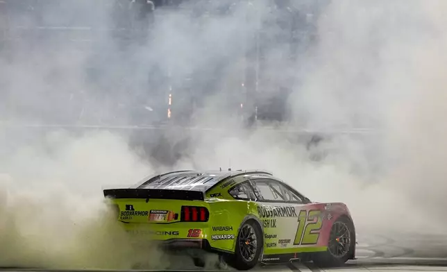 Ryan Blaney celebrates after winning a NASCAR Cup Series auto race, Sunday, July 12, 2026, in Hampton, Ga. (AP Photo/Mike Stewart)