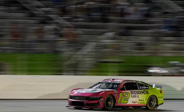Ryan Blaney (12) moves during a NASCAR Cup Series auto race, Sunday, July 12, 2026, in Hampton, Ga. (AP Photo/Mike Stewart)