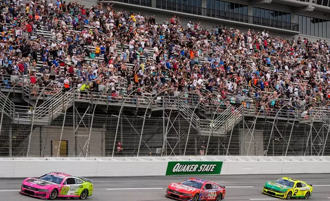 Ryan Blaney, Joey Logano, and Austin Cindric, from left, run during a NASCAR Cup Series auto race, Sunday, July 12, 2026, in Hampton, Ga. (AP Photo/Mike Stewart)