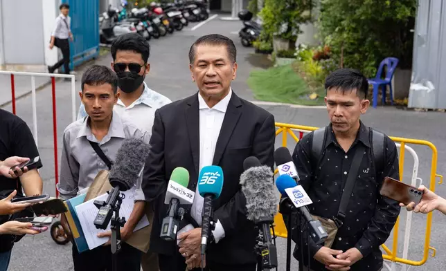 Lawyer Kunpat Singhathong and three sailors from the Thailand-flagged ship, the Mayuree Naree, speak to journalists outside the Central Labour Court in Bangkok, Thailand on Friday, July 10, 2026. (AP Photo/Anton L. Delgado)