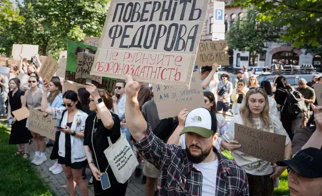 Ukranians gather to denounce President Volodymyr Zelenskyy's decision to dismiss Defense Minister Mykhailo Fedorov after six months in the post, Kyiv, Ukraine, Thursday, July 16, 2026. Placard reads: Bring back Fedorov. Do not destroy defense capability. (AP Photo/Danylo Antoniuk)