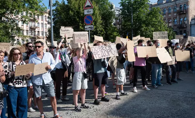 Ukranians gather to denounce President Volodymyr Zelenskyy's decision to dismiss Defense Minister Mykhailo Fedorov after six months in the post, Kyiv, Ukraine, Thursday, July 16, 2026. Placards read: "Power is the people", center left, and "Bring back Fedorov", center. (AP Photo/Danylo Antoniuk)