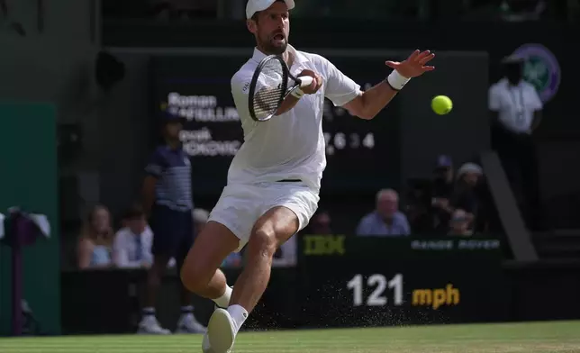 Novak Djokovic of Serbia returns the ball to Roman Saffiulin of Russia in their fourth round men's singles match at the Wimbledon Tennis Championships in London, Sunday, July 5, 2026. (AP Photo/Brian Inganga)