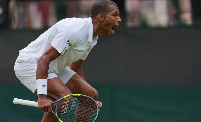 Felix Auger-Aliassime of Canada celebrates winning the men's singles fourth round match against Alejandro Davidovich Fokina of Spain at the Wimbledon Tennis Championships in London, Sunday, July 5, 2026.(AP Photo/Kin Cheung)
