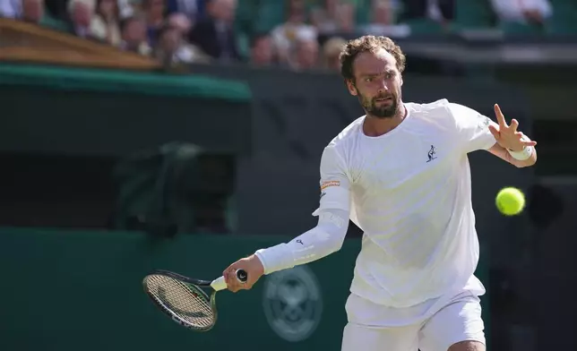 Roman Saffiulin of Russia returns the ball to Novak Djokovic of Serbia in their fourth round men's singles match at the Wimbledon Tennis Championships in London, Sunday, July 5, 2026. (AP Photo/Brian Inganga)