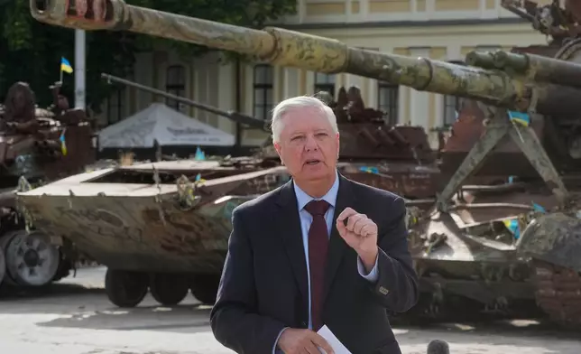 U.S. Sen. Lindsey Graham, R-S.C. answer media questions near damaged Russian tanks exhibition in central Kyiv, Friday, July 10, 2026. (AP Photo/Efrem Lukatsky)