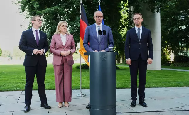 From left: Federal Chancellor Friedrich Merz arrives with Philipp Amthor, Nina Warken and Carsten Linnemann and for statement about planned personnel changes in his government at the chancellery in Berlin, Germany, Friday, July 24, 2026. (AP Photo/Markus Schreiber)