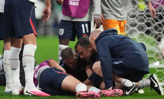 England's Jordan Henderson (14) is looked after by training staff following an injury in the postgame celebration in the World Cup round of 16 soccer match between Mexico and England in Mexico City, Sunday, July 5, 2026. (AP Photo/Eduardo Verdugo)