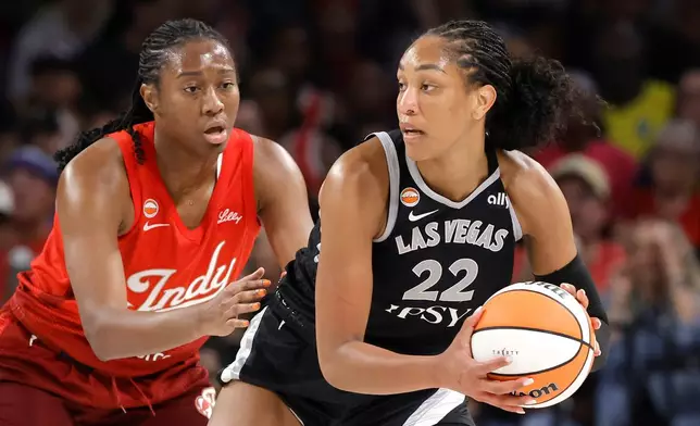 Indiana Fever center-forward Aliyah Boston, left, defends against Las Vegas Aces center A'ja Wilson (22) during the first half of an WNBA basketball game Sunday, July 12, 2026, in Las Vegas. (Steve Marcus/Las Vegas Sun via AP)