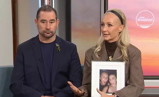 In this image made from video Michelle Jones, right, holds a photo of her daughter, Bianca, as Michelle and her husband Mark Jones appear on a news program in Melbourne, Australia, Friday, July 17, 2026. (Australian Broadcasting Corp via AP)