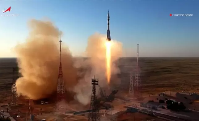 In this photo taken from video released by Roscosmos space corporation, the Soyuz-2.1 rocket booster with Soyuz MS-29 space ship carrying NASA astronaut Anil Menon, Roscosmos cosmonauts Pyotr Dubrov and Anna Kikina, a new crew to the International Space Station, ISS, blasts off in Russian leased Baikonur cosmodrome, Kazakhstan, Tuesday, July 14, 2026. (Roscosmos space corporation, via AP)