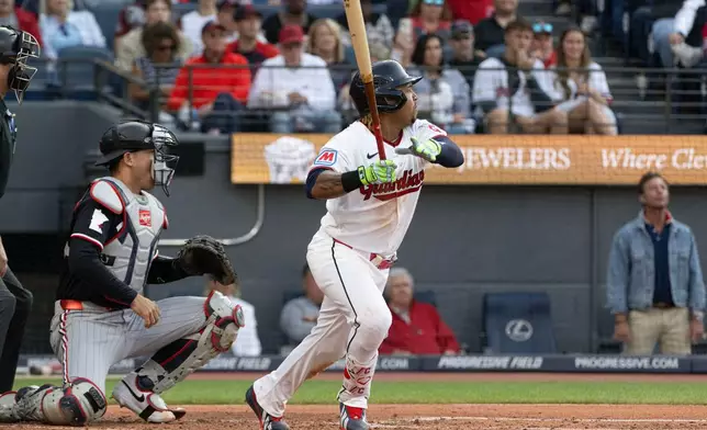 Cleveland Guardians' Jose Ramirez watches his RBI single off Minnesota Twins starting pitcher Bailey Ober as Alex Jackson looks on during the second inning of a baseball game, Wednesday, July 22, 2026, in Cleveland. (AP Photo/Phil Long)