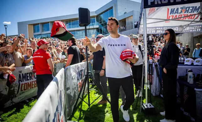 FILE - Charlie Kirk hands out hats before speaking at Utah Valley University in Orem, Utah, Sept. 10, 2025. (Tess Crowley/The Deseret News via AP, File)