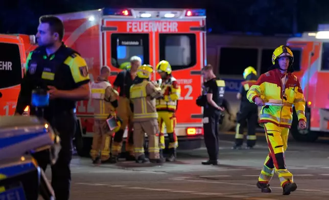 Emergency personnel gather following the cancellation of Christopher Street Day festivities in Berlin, on Saturday, July 25, 2026. (AP Photo/Markus Schreiber)