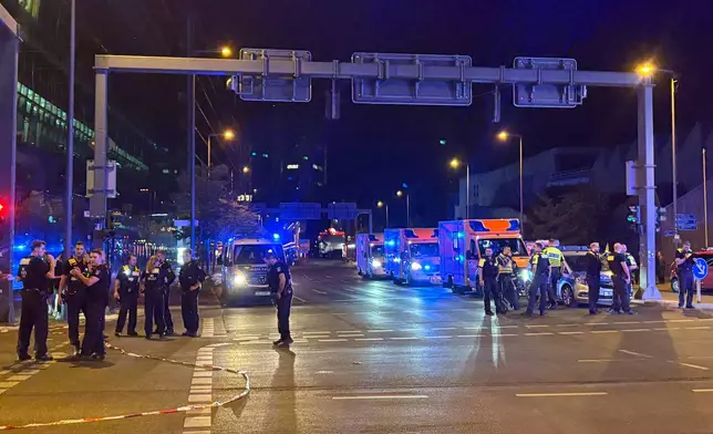 Emergency personnel gather at an intersection following the cancellation of Christopher Street Day activities in Berlin, on Saturday, July 25, 2026. (AP Photo/Fanny Brodersen)