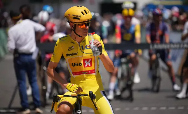 Norway's Torstein Traeen, wearing the overall leader's yellow jersey drinks water as he waits for the start of the fifth stage of the Tour de France cycling race over 158.3 kilometers (98.1 miles) with start in Lannemezan and finish in Pau, France, Wednesday, July 8, 2026. (AP Photo/Mosa'ab Elshamy)