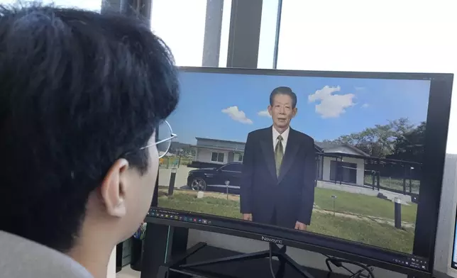 Lee Geon Hui looks at a computer screen as a video clip shows a digital likeness of his late grandfather speaking at Seoul-based tech firm Vaice, South Korea, Friday, June 12, 2026. (AP Photo/Ahn Young-joon)