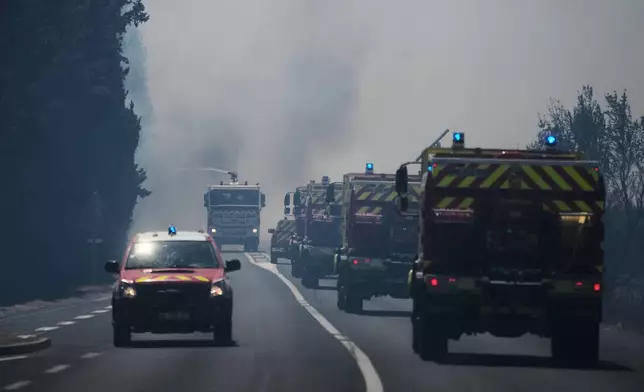 Firefighters work on a wildfire in Ille-sur-Têt, southern France, Monday, July 6, 2026. (AP Photo/Thibault Camus)