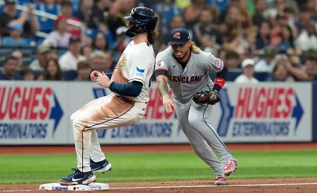 Tampa Bay Rays' Ryan Vilade, left, beats Cleveland Guardians third baseman Gabriel Arias to the base after a RBI single by Nick Fortes during the fourth inning of a baseball game Friday, July 24, 2026, in St. Petersburg, Fla. (AP Photo/Chris O'Meara)