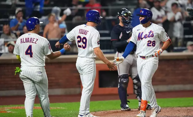 New York Mets' Tyrone Taylor (28) celebrates with teammates Jared Young (29) and Francisco Alvarez (4) after hitting a three-run home run during the seventh inning of a baseball game against the Atlanta Braves Monday, July 27, 2026, in New York. (AP Photo/Frank Franklin II)
