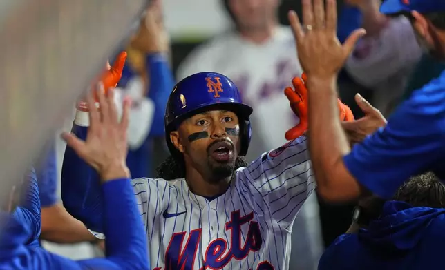 New York Mets' Francisco Lindor (12) celebrates with teammates after hitting a two-run home run during the third inning of a baseball game against the Atlanta Braves Monday, July 27, 2026, in New York. (AP Photo/Frank Franklin II)