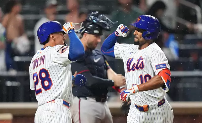 New York Mets' Marcus Semien (10) celebrates with Tyrone Taylor (28) after hitting a two-run home run during the sixth inning of a baseball game Monday, July 27, 2026, in New York. (AP Photo/Frank Franklin II)