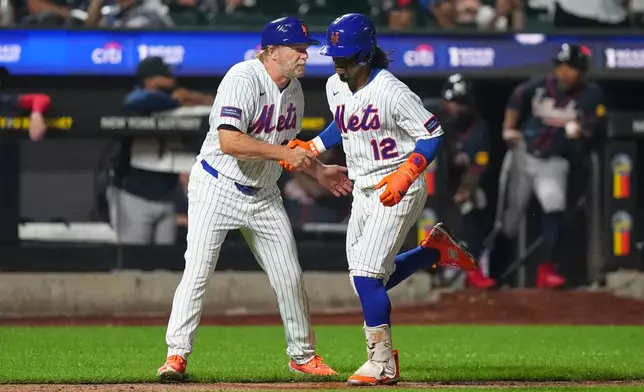 New York Mets third base coach Tim Leiper, left, celebrates with Francisco Lindor as he runs the bases after hitting a three-run home run during the eighth inning of a baseball game against the Atlanta Braves Monday, July 27, 2026, in New York. (AP Photo/Frank Franklin II)