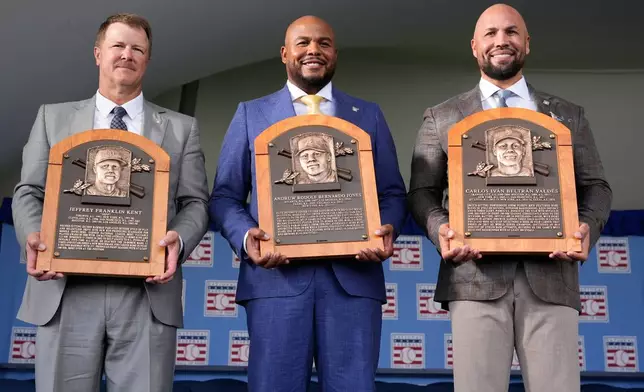 The 2026 Baseball Hall of Fame inductees Jeff Kent, left, Andruw Jones, center, and Carlos Beltran pose for pictures after the induction ceremony in Cooperstown, N.Y., Sunday, July 26, 2026. (AP Photo/Seth Wenig)