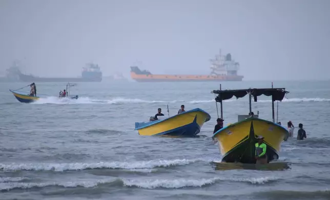 Small boats line the shore as cargo ships and other commercial vessels appear anchored in the Strait of Hormuz off Bandar Abbas, Iran, Monday, July 27, 2026. (Razieh Poudat/ISNA via AP)
