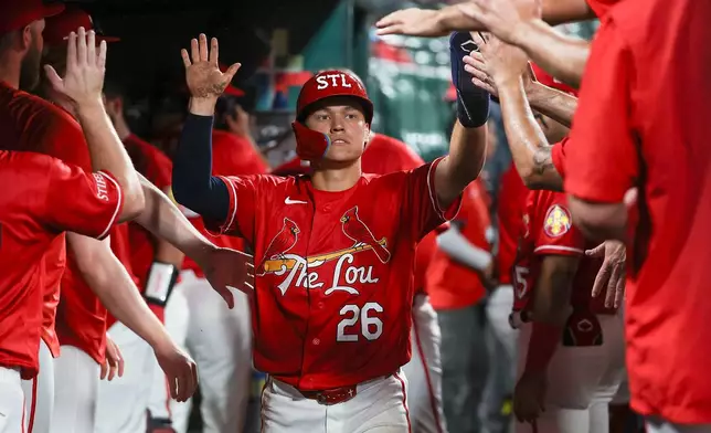 St. Louis Cardinals' JJ Wetherholt is congratulated by teammates after scoring a run during the sixth inning of a baseball game against the Atlanta Braves Friday, July 10, 2026, in St. Louis. (AP Photo/Scott Kane)