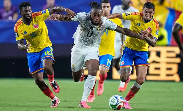 Ghana's Antoine Semenyo (11) battles for the ball Colombia's Jefferson Lerma (16) and Daniel Munoz (2) during the World Cup round of 32 soccer match between Colombia and Ghana in Kansas City, Mo., Friday, July 3, 2026. (AP Photo/Charlie Riedel)