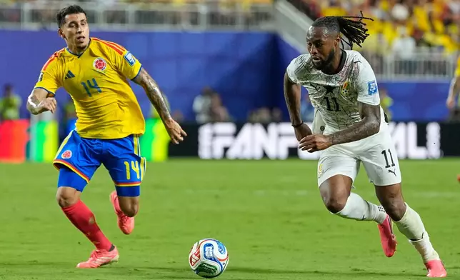 Ghana's Antoine Semenyo (11) and Colombia's Gustavo Puerta (14) battle for the ball during the World Cup round of 32 soccer match between Colombia and Ghana in Kansas City, Mo., Friday, July 3, 2026. (AP Photo/Charlie Riedel)