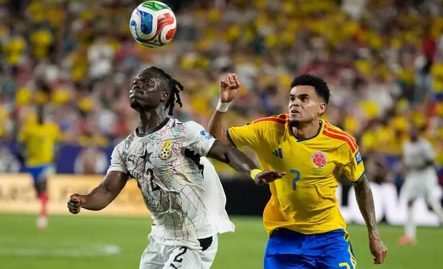 Ghana's Alidu Seidu (2) challenges for the ball with Colombia's Luis Diaz (7) during the World Cup round of 32 soccer match between Colombia and Ghana in Kansas City, Mo., Friday, July 3, 2026. (AP Photo/John Locher)