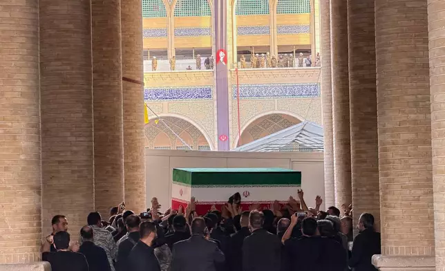 The coffin of slain Iranian Supreme Leader Ayatollah Ali Khamenei is carried into the Mosalla Grand Mosque ahead of his funeral ceremonies in Tehran, Iran, Friday, July 3, 2026. (AP Photo/Vahid Salemi)