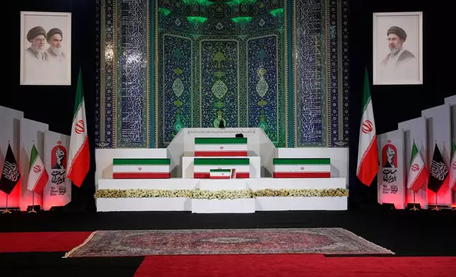 The coffins of slain Iranian Supreme Leader Ayatollah Ali Khamenei, center on top, and members of his family are displayed ahead of the dayslong funeral ceremonies at the Imam Khomeini Mosalla Grand Mosque in Tehran, Iran, Friday, July 3, 2026. (AP Photo/Vahid Salemi)