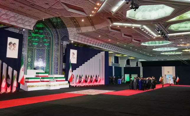 Dignitaries and officials pay their respects before the coffins of slain Iranian Supreme Leader Ayatollah Ali Khamenei and members of his family during a viewing ceremony ahead of the dayslong funeral ceremonies at the Imam Khomeini Mosalla Grand Mosque in Tehran, Iran, Friday, July 3, 2026. (AP Photo/Vahid Salemi)