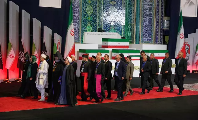 Iranian religious leaders and other mourners walk past the coffins of slain Iranian Supreme Leader Ayatollah Ali Khamenei and members of his family during a viewing ceremony ahead of the dayslong funeral ceremonies at the Imam Khomeini Mosalla Grand Mosque in Tehran, Iran, Friday, July 3, 2026. (AP Photo/Vahid Salemi) The religious leaders are Iranian, not foreigners